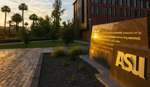 Photo of Arizona State Campus in setting sun with palm trees in the background.